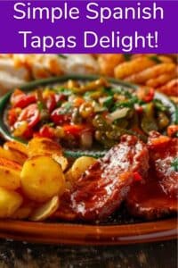A platter of colorful Spanish tapas featuring roasted potatoes, assorted vegetables, meats, and breads on a wooden table.
