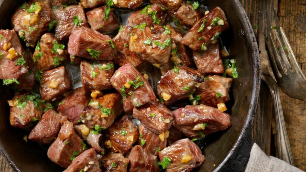 Pan-fried steak bites with garlic and herbs.