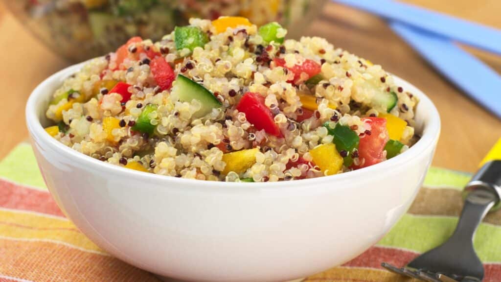 Colorful quinoa salad in white bowl