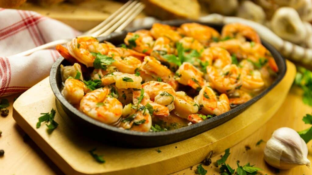Garlic shrimp in skillet with herbs