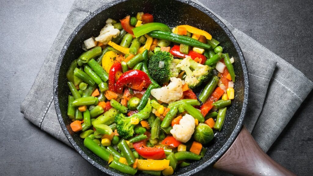 Colorful stir-fried vegetables in a pan.