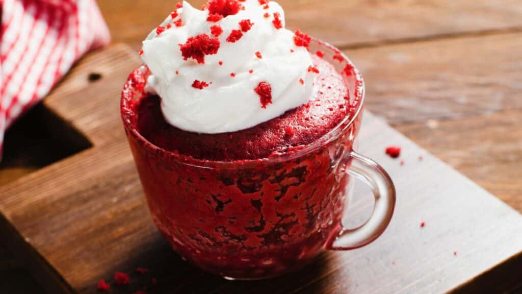Red velvet mug cake with whipped cream.