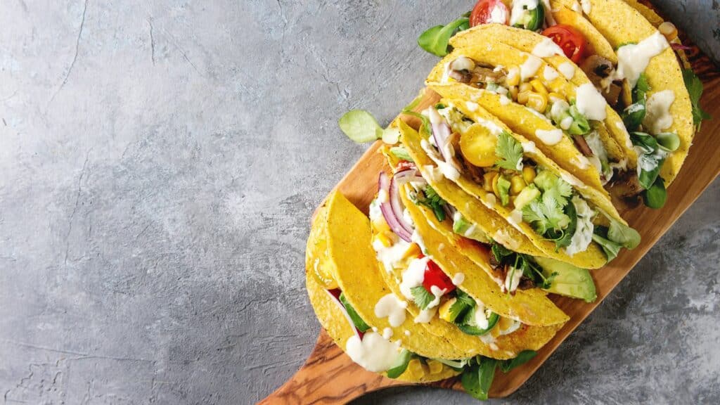 Vegetarian tacos on wooden board