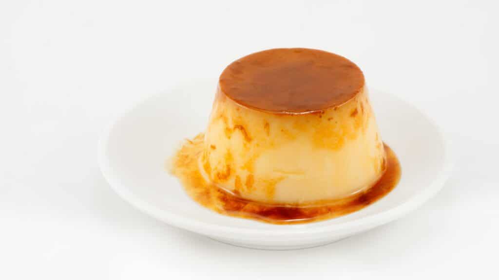 Caramel flan on white plate